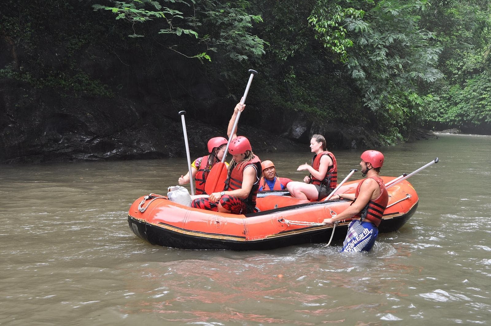 Guides and a raft in a rocky Bali river gorge